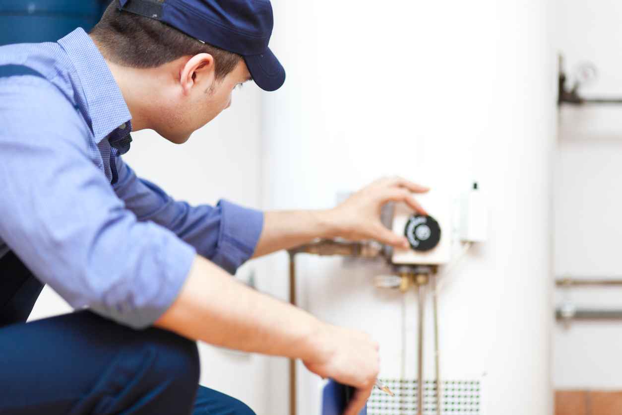 Technician repairing a hot-water heater